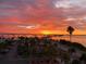 Breathtaking sunset view over the water, showcasing vibrant colors and palm tree-lined landscape at 7 Elgin Pl # 603, Dunedin, FL 34698