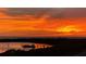 Stunning sunset scenery overlooking the bay and dock, framed by trees in a beautiful waterfront community at 7 Elgin Pl # 603, Dunedin, FL 34698