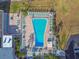 Aerial view of pool area with lounge chairs and tables at 7 Elgin Pl # 603, Dunedin, FL 34698