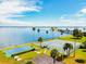A community featuring waterfront tennis and shuffleboard courts with palm trees and beautiful bay views at 7 Elgin Pl # 603, Dunedin, FL 34698
