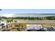 Expansive water view from the property, featuring a scenic coastal highway, mature palms, and visible parking at 7 Elgin Pl # 603, Dunedin, FL 34698