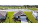 Aerial view of a charming single-Gathering home with well-manicured landscaping and a serene water view at 12815 Wanderlust Pl, Parrish, FL 34219