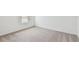 Bright and airy bedroom with neutral carpeting and a window letting in natural light at 12815 Wanderlust Pl, Parrish, FL 34219