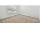 Clean bedroom with neutral carpet and a large window with blinds at 12815 Wanderlust Pl, Parrish, FL 34219