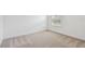 Bright bedroom features neutral carpeting and a window with wood-slat blinds at 12815 Wanderlust Pl, Parrish, FL 34219