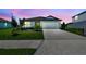 Charming home features a two-car garage, a well-kept lawn, and simple landscaping at 12815 Wanderlust Pl, Parrish, FL 34219