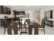 Beautiful kitchen with dark cabinets, stainless steel appliances, and a large center island at 12815 Wanderlust Pl, Parrish, FL 34219
