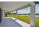 Covered patio overlooking the beautiful backyard, lawn, and pond at 12815 Wanderlust Pl, Parrish, FL 34219