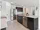 Kitchen featuring a large island, stainless steel appliances, and dark wood cabinets at 12819 Wanderlust Pl, Parrish, FL 34219