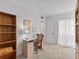 Bright bedroom with a built-in desk, wood bookcase, neutral carpeting, and access to the ensuite bathroom at 1581 Amberlea S Dr, Dunedin, FL 34698