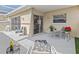 Covered patio features neutral concrete, seating arrangements, glass sliding doors and bright natural light at 1581 Amberlea S Dr, Dunedin, FL 34698
