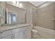 Bathroom featuring granite counters, white cabinets, and a shower over the bath at 2402 Cumberland Cliff Dr, Ruskin, FL 33570