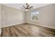 Bedroom featuring wood-look floors, a ceiling fan, and a window at 2402 Cumberland Cliff Dr, Ruskin, FL 33570
