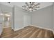Bedroom featuring wood-look floors, a ceiling fan, and an ensuite bathroom at 2402 Cumberland Cliff Dr, Ruskin, FL 33570