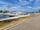 Scenic marina showcasing yachts and sailboats along a dock, creating a vibrant waterfront scene under a clear blue sky with clouds at 2402 Cumberland Cliff Dr, Ruskin, FL 33570