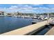 Picturesque marina featuring a variety of boats docked along the pier, set against a backdrop of waterfront homes and a blue sky at 2402 Cumberland Cliff Dr, Ruskin, FL 33570
