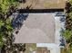 Overhead view of a home's roof, concrete patio, and surrounding green trees at 8902 Temple Park Dr, Tampa, FL 33637