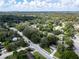 A panoramic aerial shot showcases the neighborhood with mature trees, wide streets, and a tranquil suburban setting at 8902 Temple Park Dr, Tampa, FL 33637