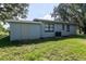 Home exterior shows a grass lawn and part of the house with a door and window at 8902 Temple Park Dr, Tampa, FL 33637