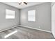 Clean and bright empty bedroom with a ceiling fan, carpeted floor and a large window at 8902 Temple Park Dr, Tampa, FL 33637