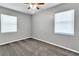 Neutral bedroom with carpet, windows, ceiling fan, grey walls and white trim, offering a blank canvas at 8902 Temple Park Dr, Tampa, FL 33637