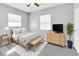 Comfortable bedroom with a bed, bench, dresser, and large windows, creating a relaxing atmosphere at 8902 Temple Park Dr, Tampa, FL 33637