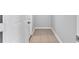 Neutral hallway featuring tiled flooring, connecting various parts of the home at 8902 Temple Park Dr, Tampa, FL 33637