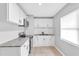 Bright kitchen with white cabinets, granite countertops, stainless appliances, and neutral tile flooring at 8902 Temple Park Dr, Tampa, FL 33637