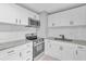 Stylish kitchen features white cabinets, stainless steel appliances, and granite countertops at 8902 Temple Park Dr, Tampa, FL 33637