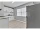 Efficient kitchen space featuring white cabinets, stainless steel appliances, and a tiled floor at 8902 Temple Park Dr, Tampa, FL 33637