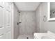 Bathroom view features a modern stand up shower with marble tile, sleek fixtures, and a glass door at 8902 Temple Park Dr, Tampa, FL 33637