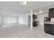 Open concept floor plan boasting tile floors and black kitchen appliances with granite countertops at 107 Seahorse Se Dr # A, St Petersburg, FL 33705