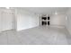 Bright living room features white tiled floor and an open floor plan with a view of the modern kitchen at 107 Seahorse Se Dr # A, St Petersburg, FL 33705
