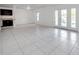 Open concept floor plan featuring white tiled floor and lots of natural light from windows and glass doors at 107 Seahorse Se Dr # A, St Petersburg, FL 33705