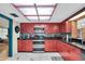 Bright kitchen with stainless steel appliances, red cabinetry and a skylight offering a unique and functional space at 1545 Park N St, St Petersburg, FL 33710