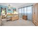 Bright main bedroom with blue accent wall, a ceiling fan, and neutral colored carpet at 1545 Park N St, St Petersburg, FL 33710