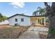 Rear exterior shot revealing a carport with ceiling fan and the home's clean lines at 4215 E Paris St, Tampa, FL 33610
