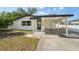 Exterior shot showing the front entrance and a convenient covered carport at 4215 E Paris St, Tampa, FL 33610