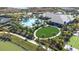 Aerial view of the pool and clubhouse featuring a green lawn and walking path at 4639 Garofalo Rd, Wesley Chapel, FL 33543