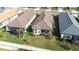 Beautiful aerial view of a home with a screened lanai and well-manicured lawn at 4639 Garofalo Rd, Wesley Chapel, FL 33543