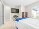 Relaxing bedroom with minimalist décor and ample natural light, perfect for unwinding at 4639 Garofalo Rd, Wesley Chapel, FL 33543