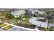 Clubhouse exterior with circular driveway, well manicured landscaping, and parking lot at 4639 Garofalo Rd, Wesley Chapel, FL 33543