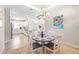 Cozy dining area adjacent to the kitchen, featuring a round table, chandelier, and neutral decor at 4639 Garofalo Rd, Wesley Chapel, FL 33543