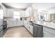 Well-lit kitchen with stainless steel appliances, white cabinetry, and an open view to the adjacent living spaces at 4639 Garofalo Rd, Wesley Chapel, FL 33543