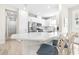 Bright kitchen with white cabinetry, stainless steel appliances, and a quartz countertop island with bar seating at 4639 Garofalo Rd, Wesley Chapel, FL 33543