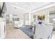 Spacious living area showcasing an open layout connecting to the kitchen, with light-colored furniture and decor at 4639 Garofalo Rd, Wesley Chapel, FL 33543