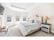 Serene bedroom with tray ceiling, neutral color scheme, three windows, and comfortable furnishings at 4639 Garofalo Rd, Wesley Chapel, FL 33543