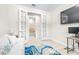 Office space featuring french doors and a view into the bathroom, equipped with a workspace and cozy seating at 4639 Garofalo Rd, Wesley Chapel, FL 33543
