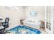 Comfortable home office featuring a blue area rug, a desk, and a couch at 4639 Garofalo Rd, Wesley Chapel, FL 33543
