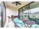 Inviting covered patio with comfortable seating and ceiling fan, ideal for outdoor relaxation and dining at 4639 Garofalo Rd, Wesley Chapel, FL 33543